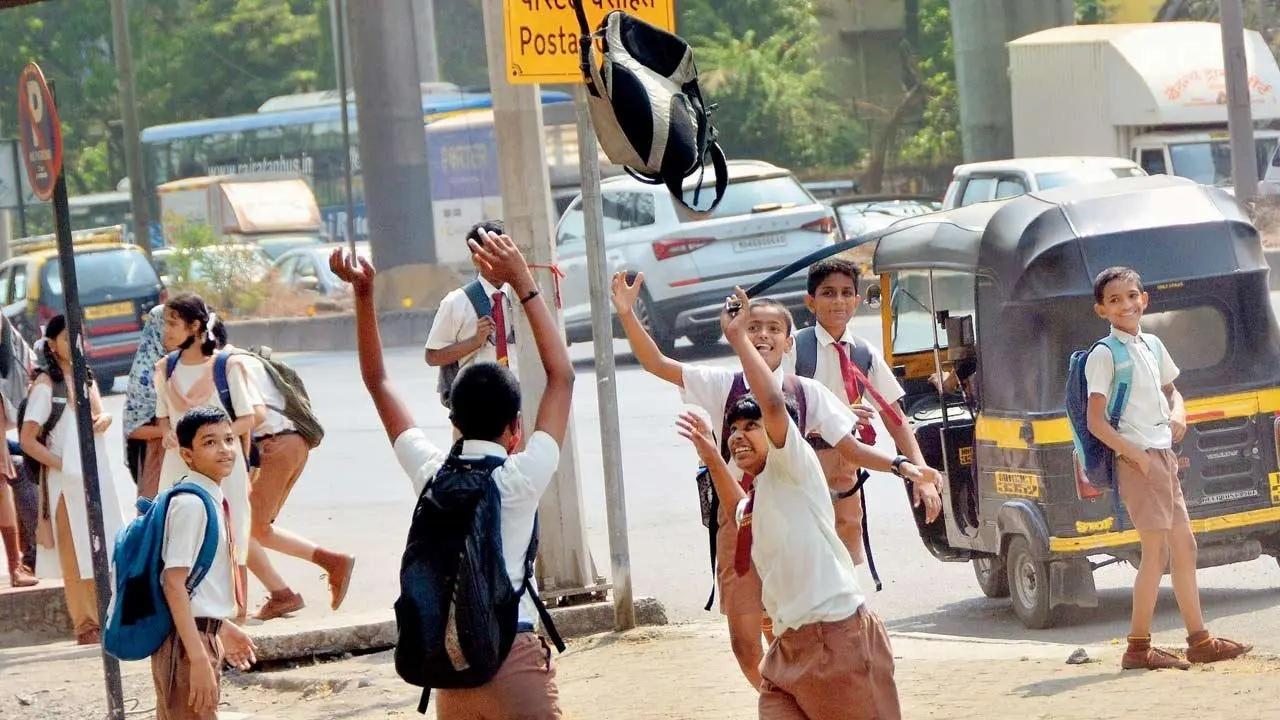Their bag of tricks: School children have a ball while tossing up their bags in Chembur on the Eastern Express Highway. Pic/Sayyed Sameer Abedi
